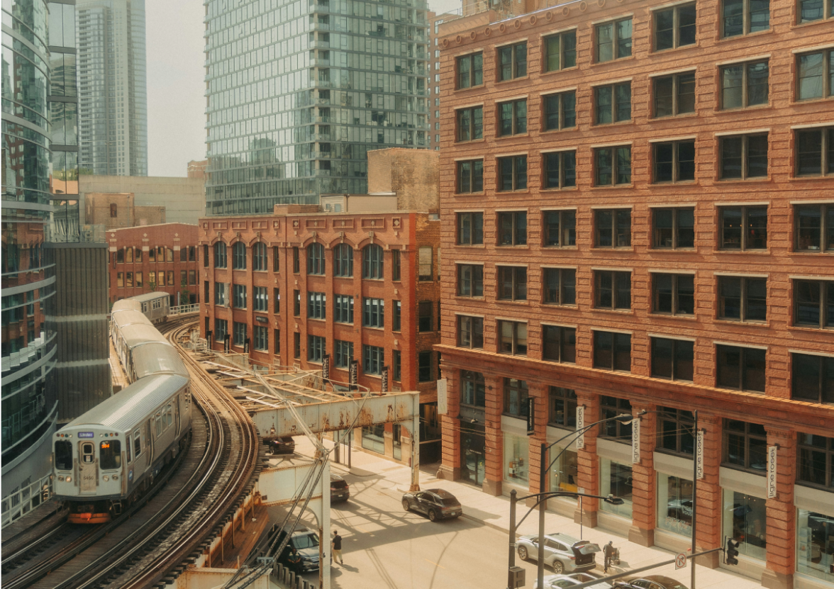 A train traveling through Chicago, Illinois next to tall buildings.