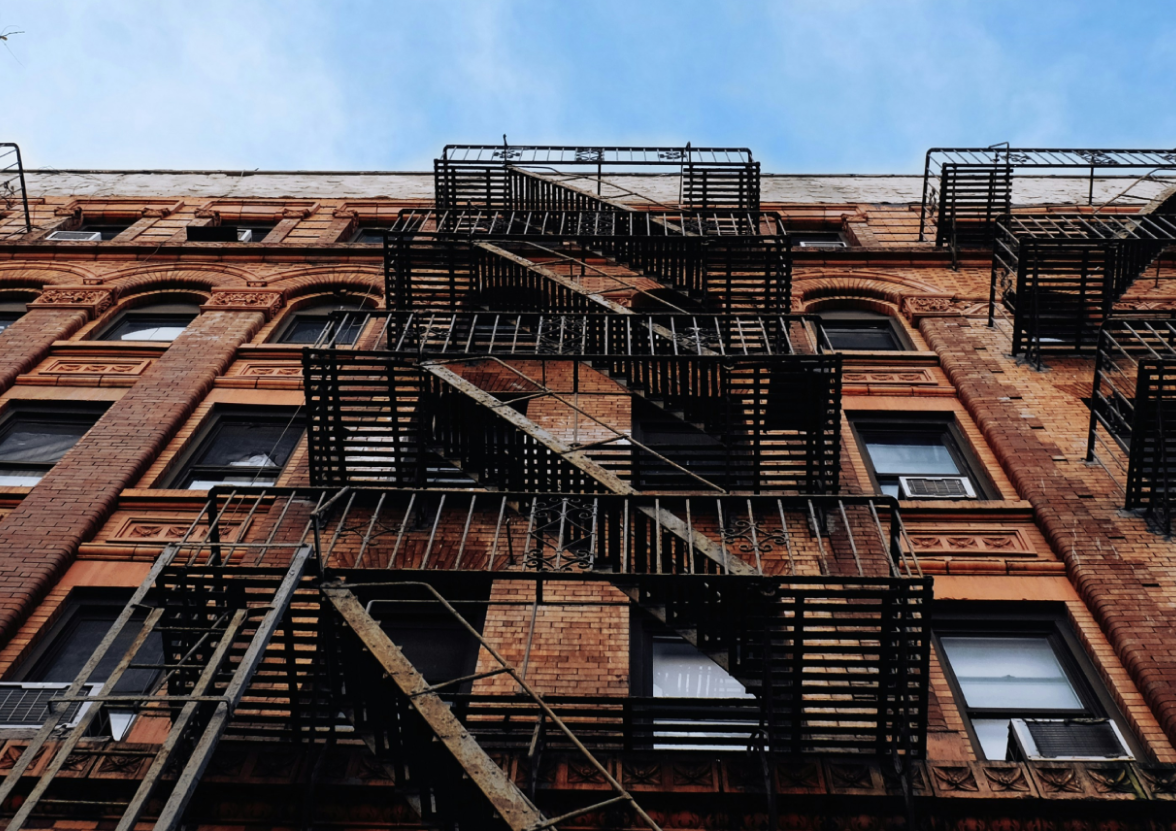 A worm's-view of a brown brick building in Williamsburg, New York.