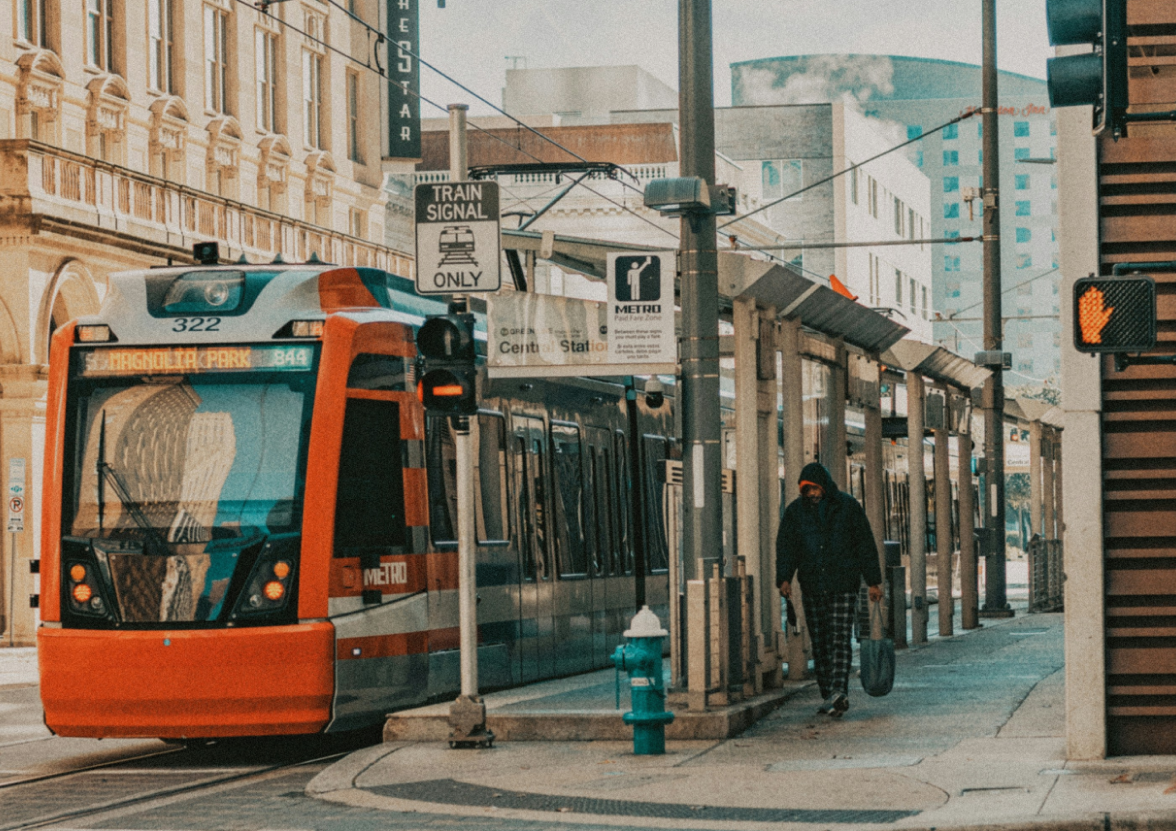 Orange metro tram on the street during daytime in downtown Houston, Texas.